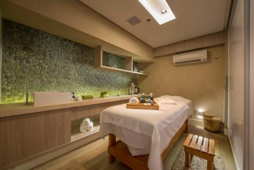 a hospital room with a table and a sink at Hotel White House in Anuradhapura