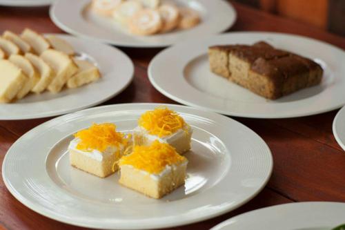 a table topped with white plates with different types of cakes at Chiang Dao Reset in Chiang Dao