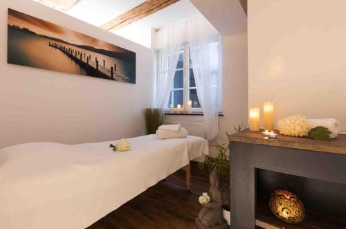 a living room with a bed and a fireplace at Bodensee Hotel Storchen in Uhldingen-Mühlhofen