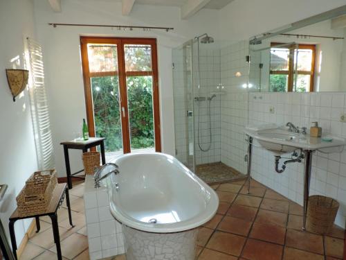 a bathroom with a bath tub and a sink at Haus Katha Koserow in Ostseebad Koserow