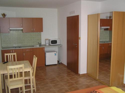 a small kitchen with a table and a microwave at Penzion U Zamku in Lednice