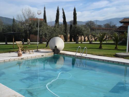 a swimming pool in a villa with a garden at Posada Tresmentiras in Aldeanueva del Camino
