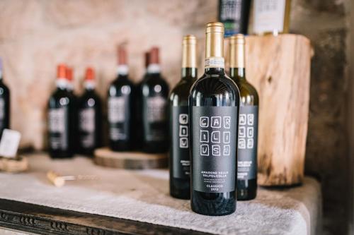 a group of bottles of wine sitting on a counter at B&B - Relais de charme la Caminella in San Pietro in Cariano