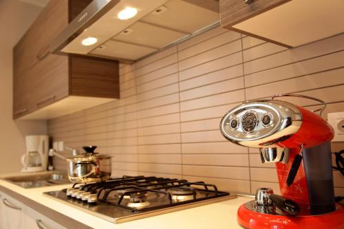 a red mixer sitting on top of a stove in a kitchen at Villa Perla del Lago in Vercana
