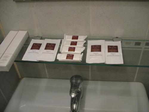 a shelf above a sink with books on it at Premier Club in Chernivtsi