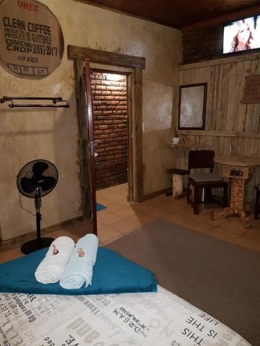 a room with two white towels on a bed at Thandamanzi Self Catering in Sabie