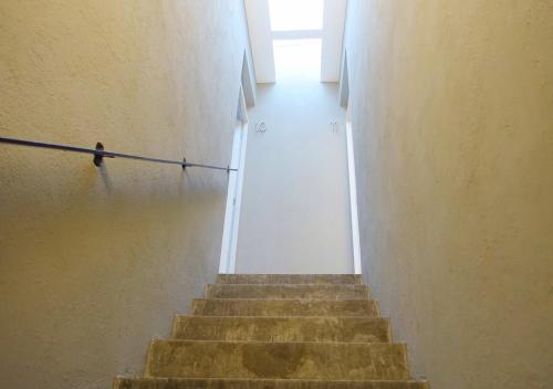 a staircase in a building with a person walking down it at Hotel Mamá Carlota in Querétaro