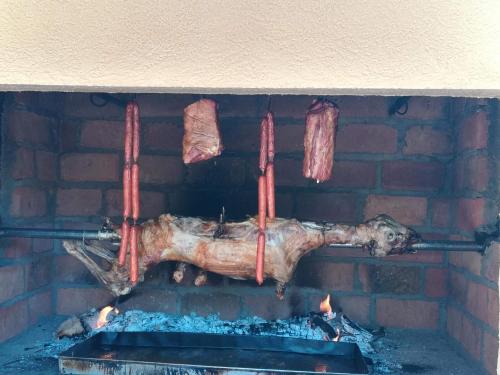 a brick oven with meat and sausages at LAZAREV KONAK in Banja Koviljača