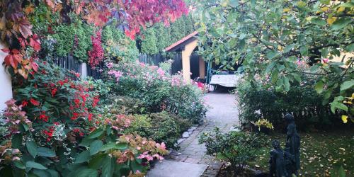 a garden with colorful flowers and a fence at Słoneczne apartamenty in Sobótka