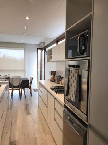a kitchen with a stove top oven next to a table at Aizarker in La Plata