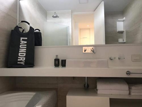a bathroom with a sink and a large mirror at Aizarker in La Plata