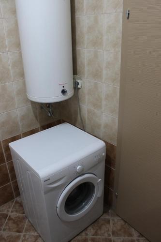 a white washer and dryer in a bathroom at Vasilij Lake view in Ohrid