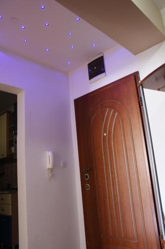 a room with a wooden door and a tv on the ceiling at Vasilij Lake view in Ohrid