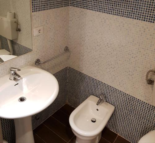 a bathroom with a sink and a toilet at Le antiche mura 2 in Sassari