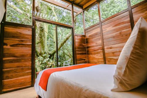 a bedroom in a tree house in the woods at Casa Higueron in Monteverde Costa Rica