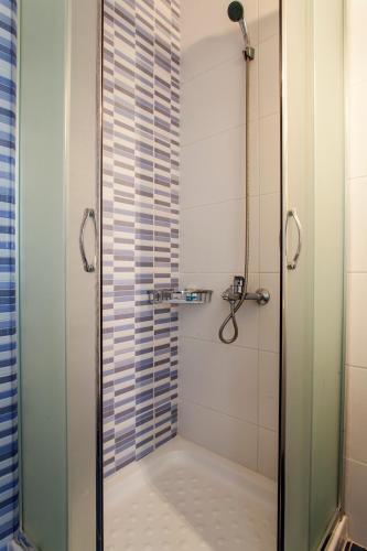 a shower with a glass door in a bathroom at Mythos Suites Diskos in Léntas