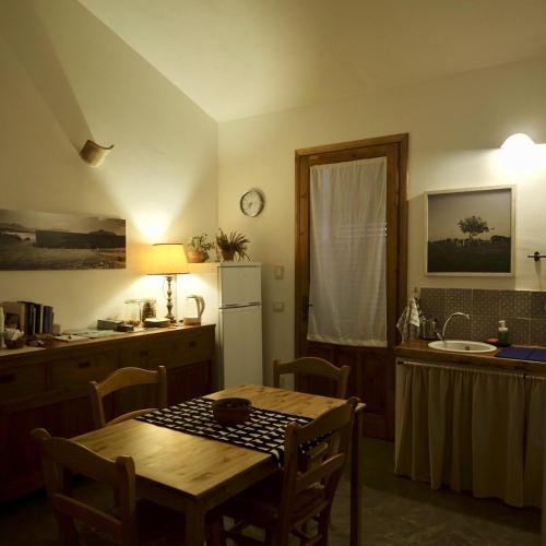 a kitchen with a table and a sink and a refrigerator at Stagnone Area Zero in Birgi Vecchi