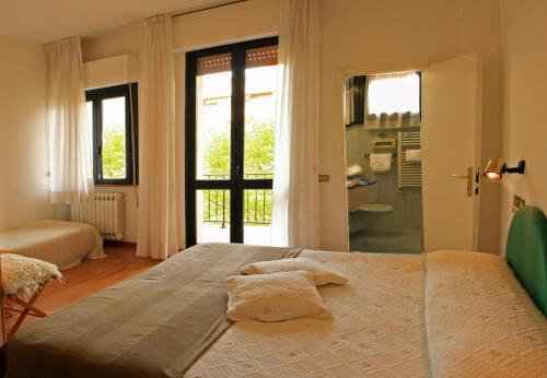 Postel nebo postele na pokoji v ubytování Hotel Aggravi