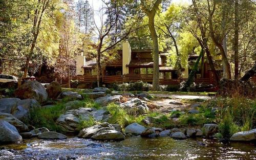 a house with a river in front of a house at Junipine Resort in Sedona