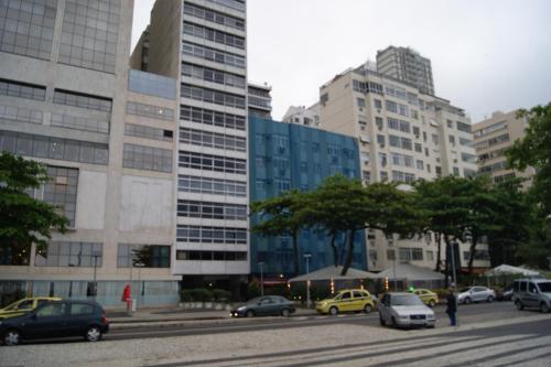 a city street with cars parked in front of buildings at xxxxxxxxxxxxxxxx in Rio de Janeiro