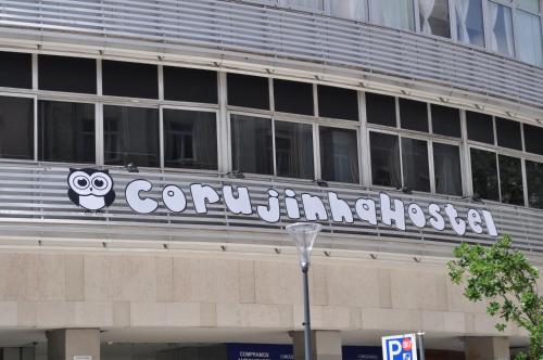 a building with a sign on the side of it at Corujinha Hostel in Lisbon