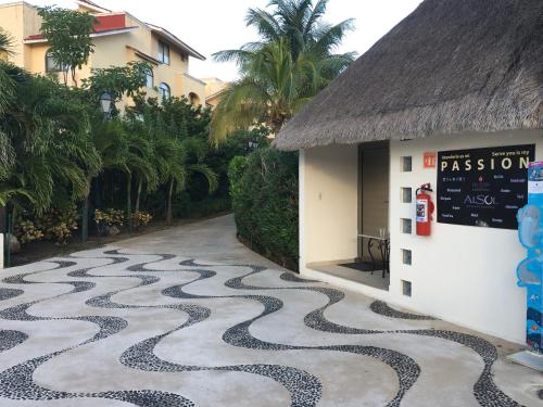 a cobblestone walkway in front of a building at Tropical apartment in Cancún