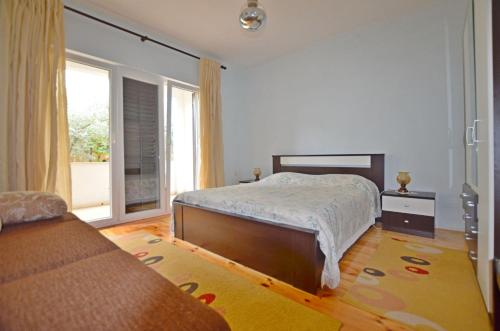 a bedroom with a bed and a large window at Apartment Velimir in Poreč