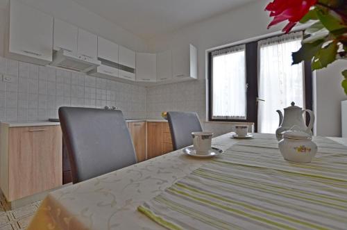 a kitchen with a table with a vase on it at Apartment Velimir in Poreč
