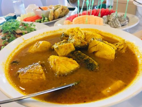 a plate of food with a bowl of soup at K Park Grand Hotel in Surat Thani