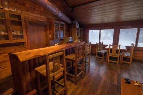 a dining room with a bar in a cabin at The Yurts at Margo's Garden, Kiroro in Akaigawa