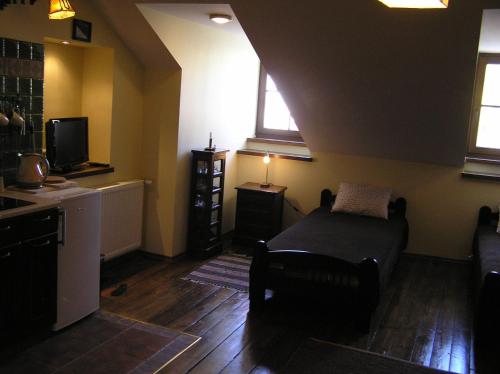a living room with a bed and a tv at Lublin Apartaments in Lublin