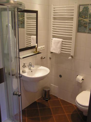 a bathroom with a sink and a toilet at Lublin Apartaments in Lublin