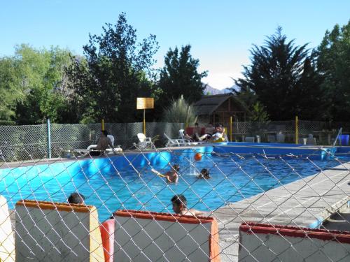 a group of people swimming in a swimming pool at Cabañas Ranquil Luncay in Uspallata
