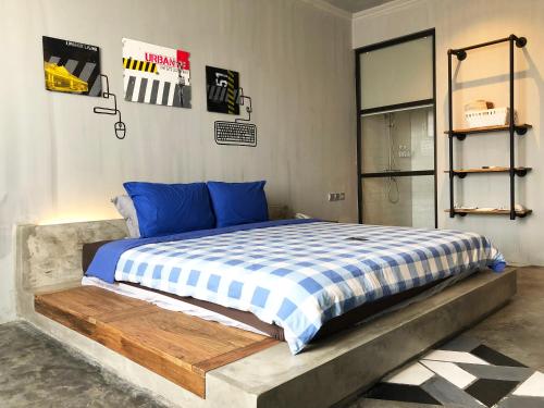 a bedroom with a bed with blue and white sheets at the AMARTYA in Yogyakarta