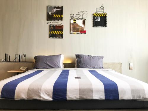 a bed with a blue and white striped comforter in a room at the AMARTYA in Yogyakarta