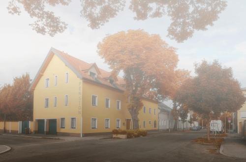 a large yellow house on the side of a street at Pension Kasper in Vienna