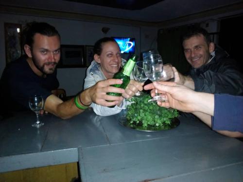 a group of people holding up wine glasses at a table at Rena Akasha Establishments in Kyenjojo