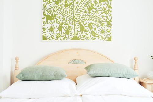a bed with two pillows on top of it at Weingarten Lodge in Winten