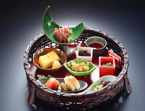 a table with a basket of food on it at Balinese onsen ryokan Hakone Airu in Hakone