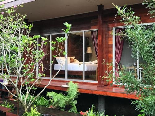 a room with a bed inside of a house at 88 Homestay in Bang Chak