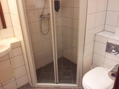 a bathroom with a shower stall and a toilet at P-Hotels Oslo in Oslo
