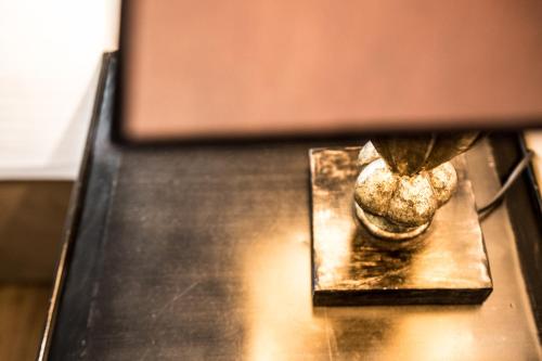 a metal object sitting on top of a table at Hotel Du Midi in Visan