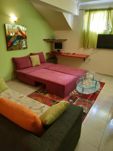 a living room with two beds and a table at Modern Basement Apartment Gio Ii in Zakynthos Town