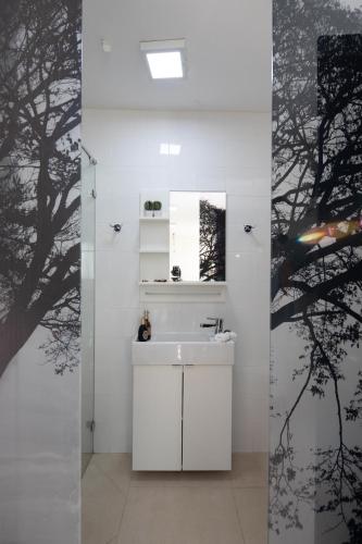 a bathroom with a white sink and a mirror at DesertB in Giv'ot Bar
