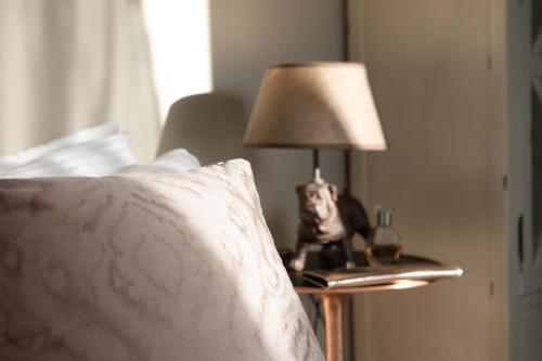 a lamp on a night stand next to a bed at DesertB in Giv'ot Bar