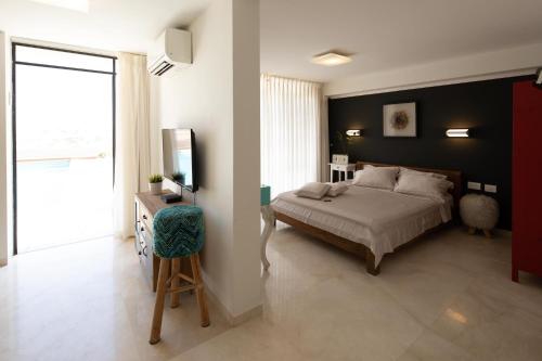 a bedroom with a bed and a large window at DesertB in Giv'ot Bar