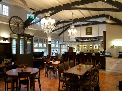 a restaurant with tables and chairs in a room at Fox and Grapes in London