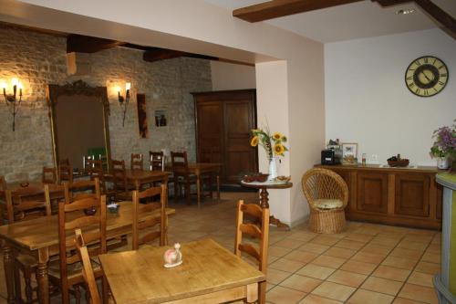 a dining room with wooden tables and chairs at Hôtel République in Dijon