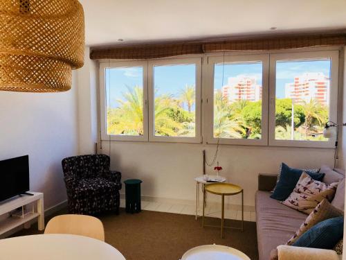 a living room with a couch and two windows at Cabo Palos Apt Salinas Marchamalo*Playa Amoladeras in Cabo de Palos