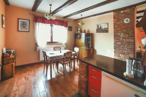 a kitchen with a table and a dining room at Studio apartman Vuković in Varaždin